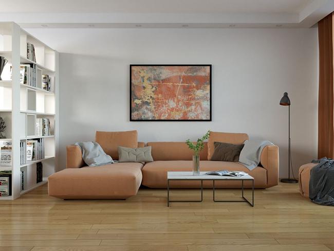 Modern living room with a beige sectional sofa, abstract wall art, and oak flooring – guide on how to choose best oak flooring.